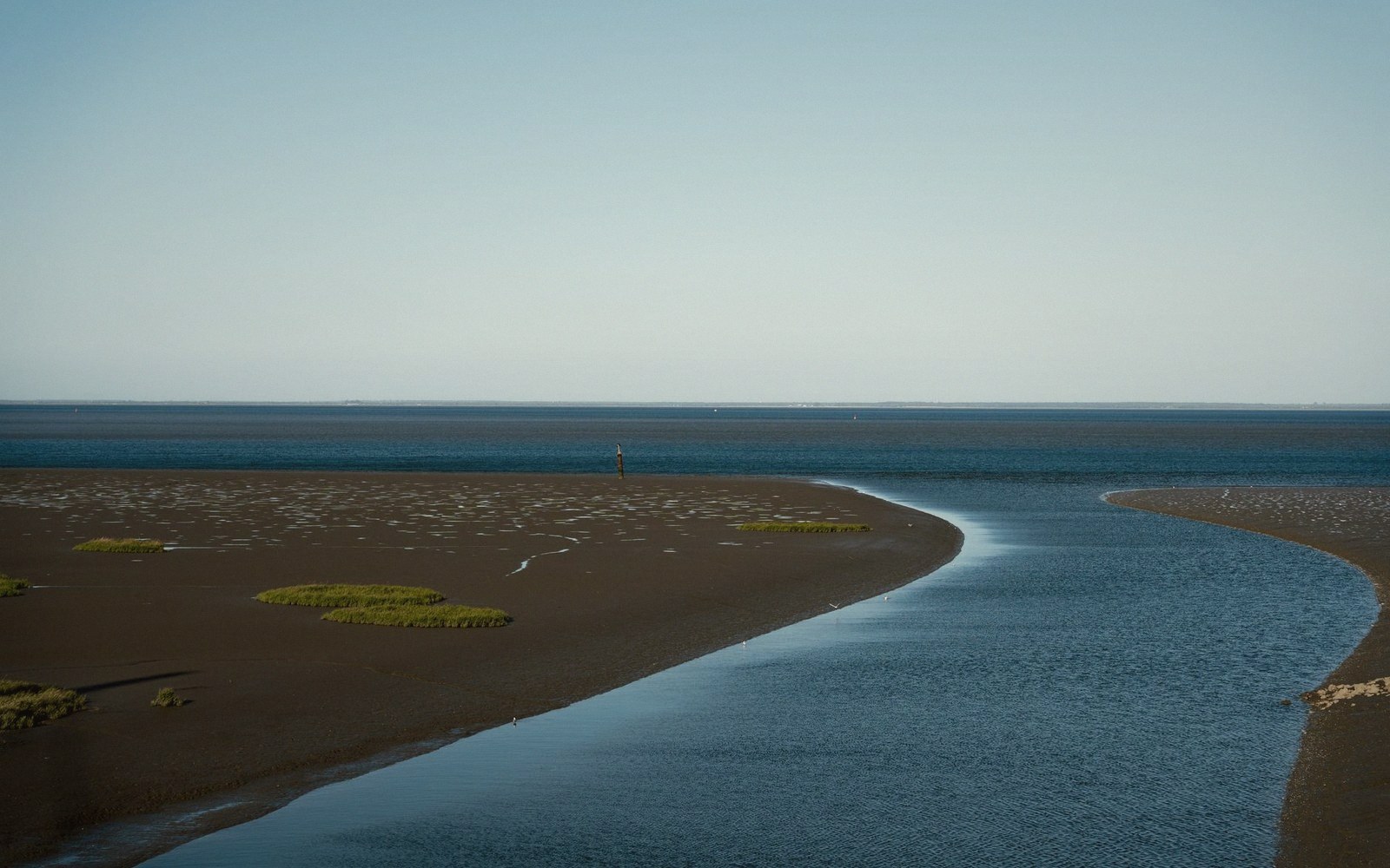 The estuary at low water, mudbanks showing, horizon high